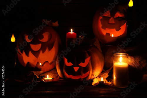 Halloween pumpkins with candle on brown wooden table