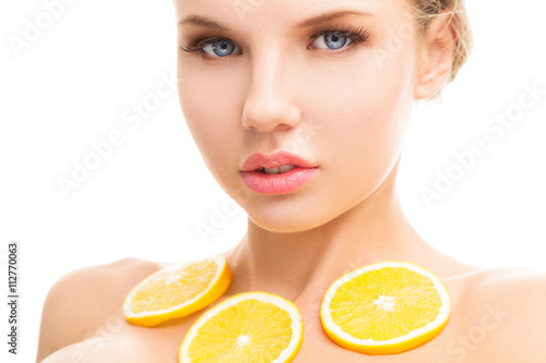 Young woman with orange in her hands