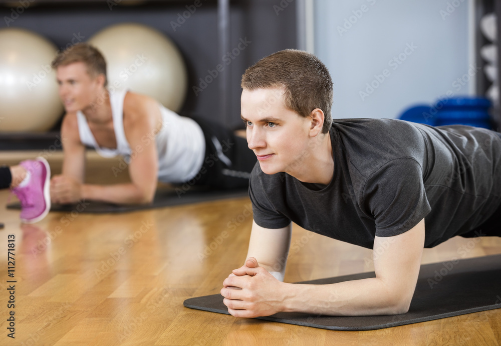 Man Performing Plank Position In Gym Man Performing Plank Position In Gym