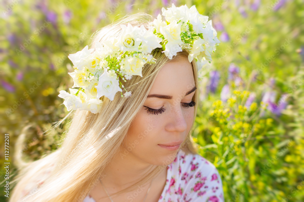 Young female with blond hair and flower coronet Young female with blond hair and flower coronet