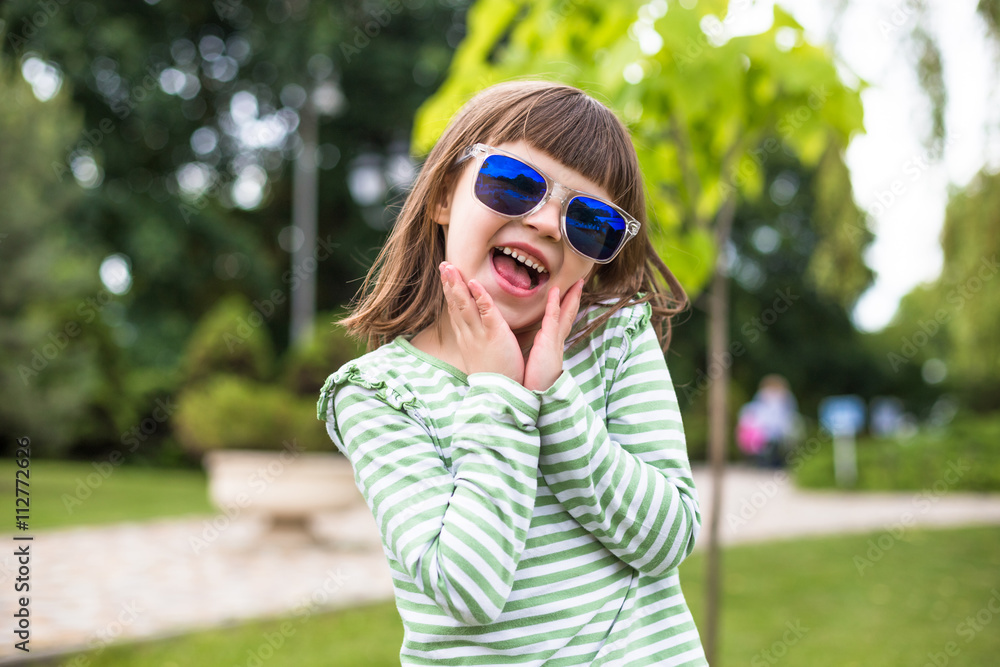 Happy child playing in city park. Summer sunny picture Happy child playing in city park. Summer sunny picture