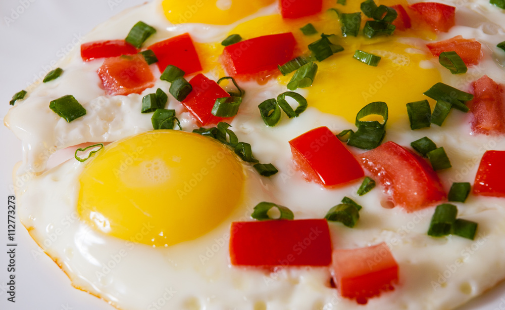 fried eggs with vegetables on plate fried eggs with vegetables on plate