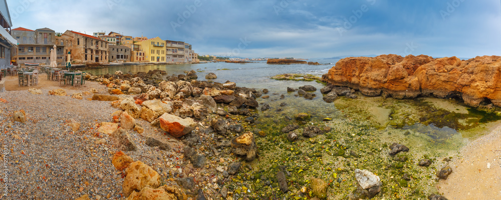 Empty outdoor cafe on the seashore in the cloudy morning, Chania, Crete, Greece Empty outdoor cafe on the seashore in the cloudy morning, Chania, Crete, Greece