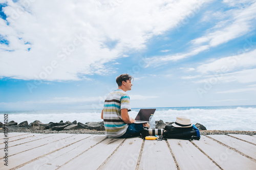 Business man working on the beach with a laptop