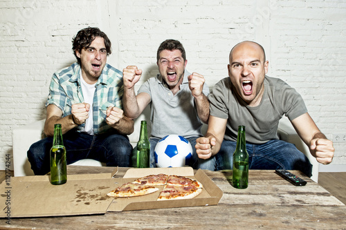 Fotografía friends fanatic football fans watching game on tv celebrating goal screaming cra