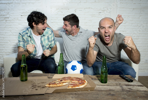 Fotografía friends fanatic football fans watching game on tv celebrating goal screaming cra