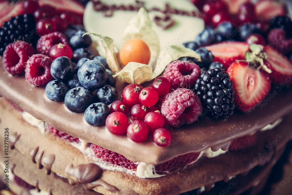 layer cake with mixed berries on top for for celebration event layer cake with mixed berries on top for for celebration event