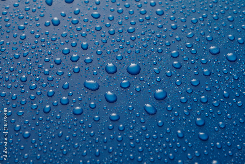 Water drops or raindrops on blue metal Water drops or raindrops on blue metal