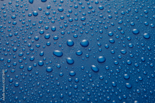 Water drops or raindrops on blue metal