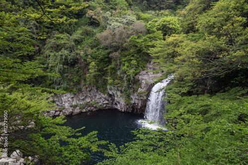 Third tier of the Cheonjeyeon Falls on Jeju Island in South Korea viewed from above.