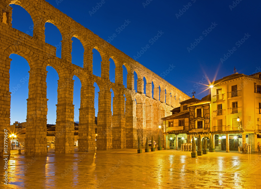 SEGOVIA, SPAIN, APRIL - 13, 2016: Aqueduct of Segovia and Plaza del Azoguejo at dusk.
