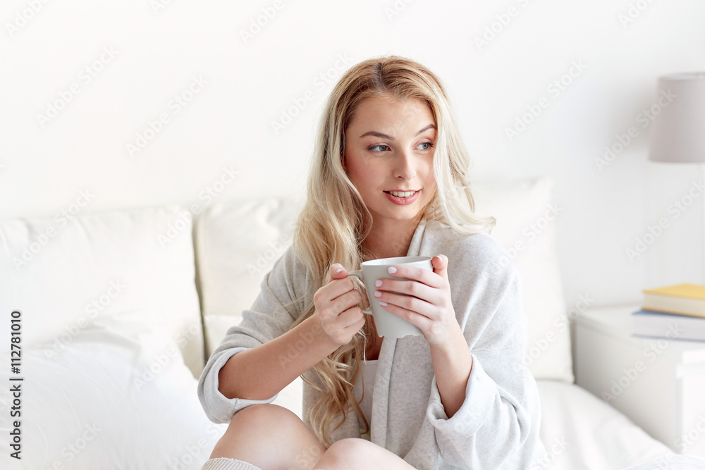 happy woman with cup of coffee in bed at home happy woman with cup of coffee in bed at home