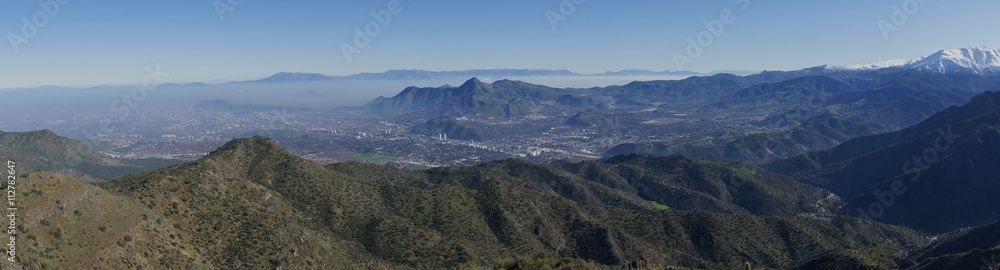 Panoramic view of Santiago, capital of Chile. Viewed from Parque Puente Nilhue in the foothills of the Andes Mountains looking towards Cerro Manquehue (1,635m).