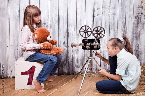 children with a vintage movie camera