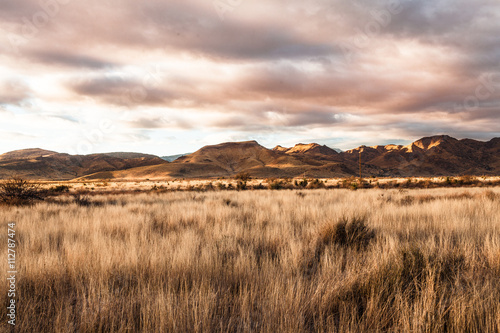 Fields by mountains