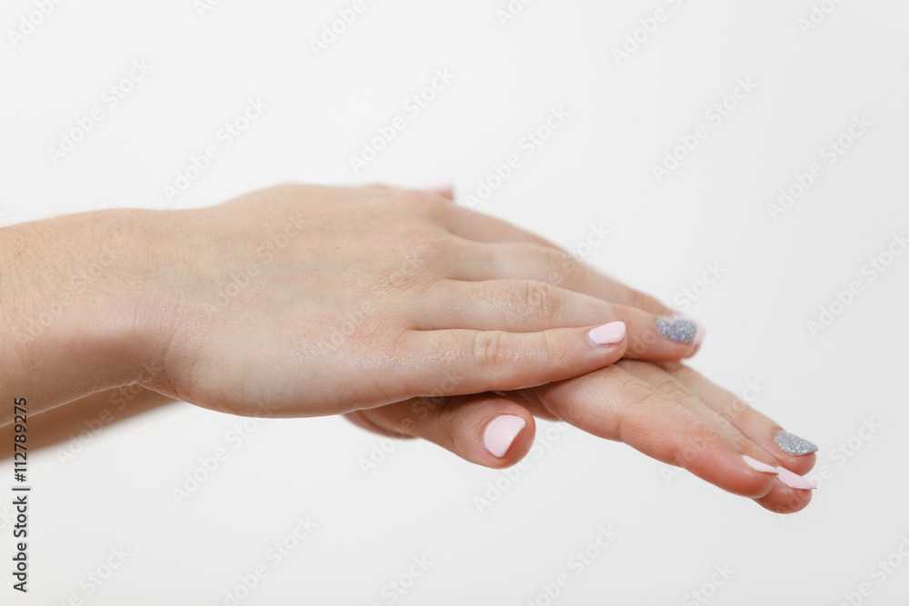 Woman taking care of her dry hands applying cream. Woman taking care of her dry hands applying cream.