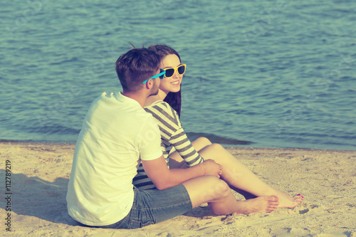 Young couple sitting on beach