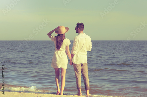 Young couple holding hands ...