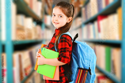 Girl with books in school l...