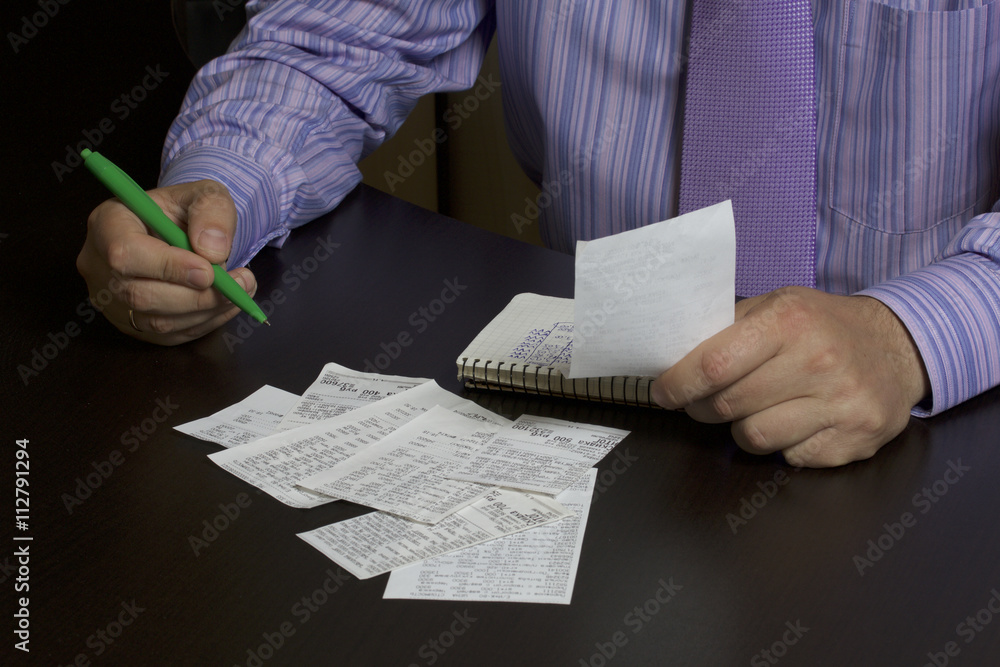 The man counts the cost of cash Cheques. A family budget. Cheques are ...