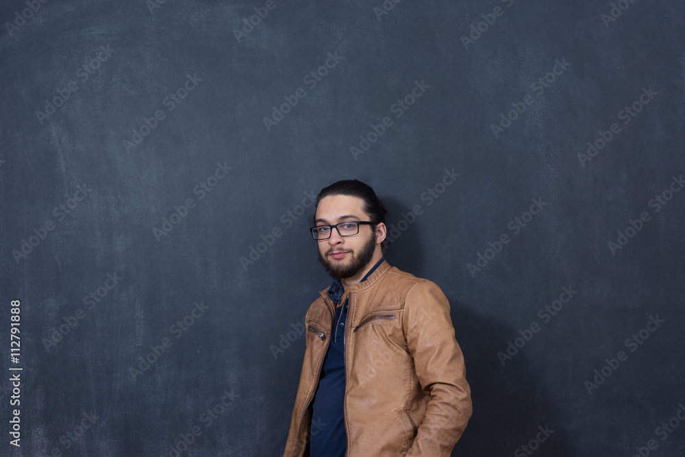 Attractive young man against blackboard. Attractive young man against blackboard.