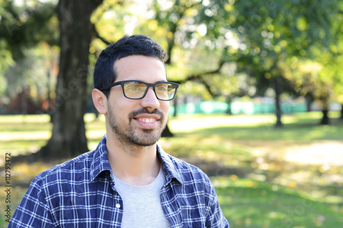 Close up of young man in a park.