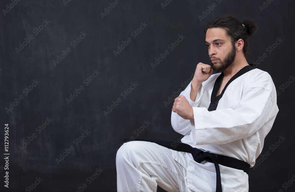 White Karate Fighter Isolated On Black With Copyspace