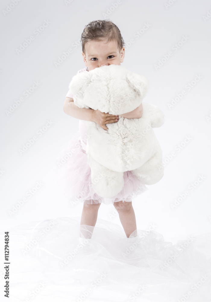 Little Caucasian Cute Female Child. Posing with Toy Against White Little Caucasian Cute Female Child. Posing with Toy Against White