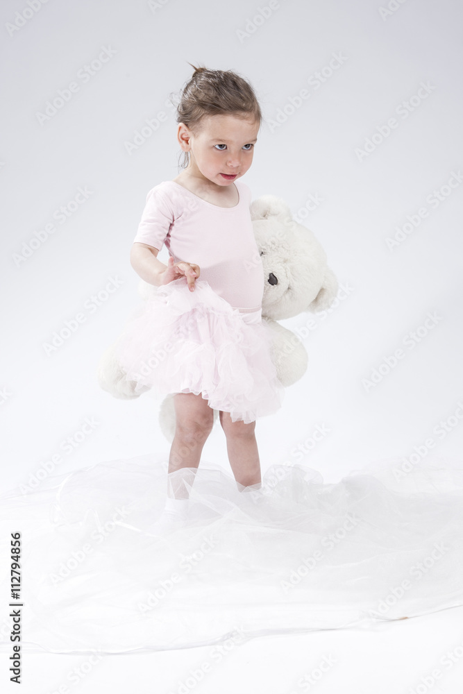Portrait of Little Caucasian Cute Female Child. Posing with Toy Portrait of Little Caucasian Cute Female Child. Posing with Toy