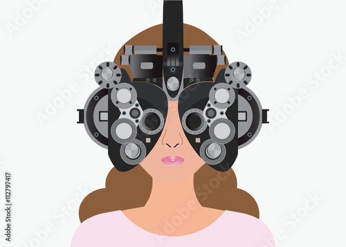 Woman looking through phoropter during eye exam.