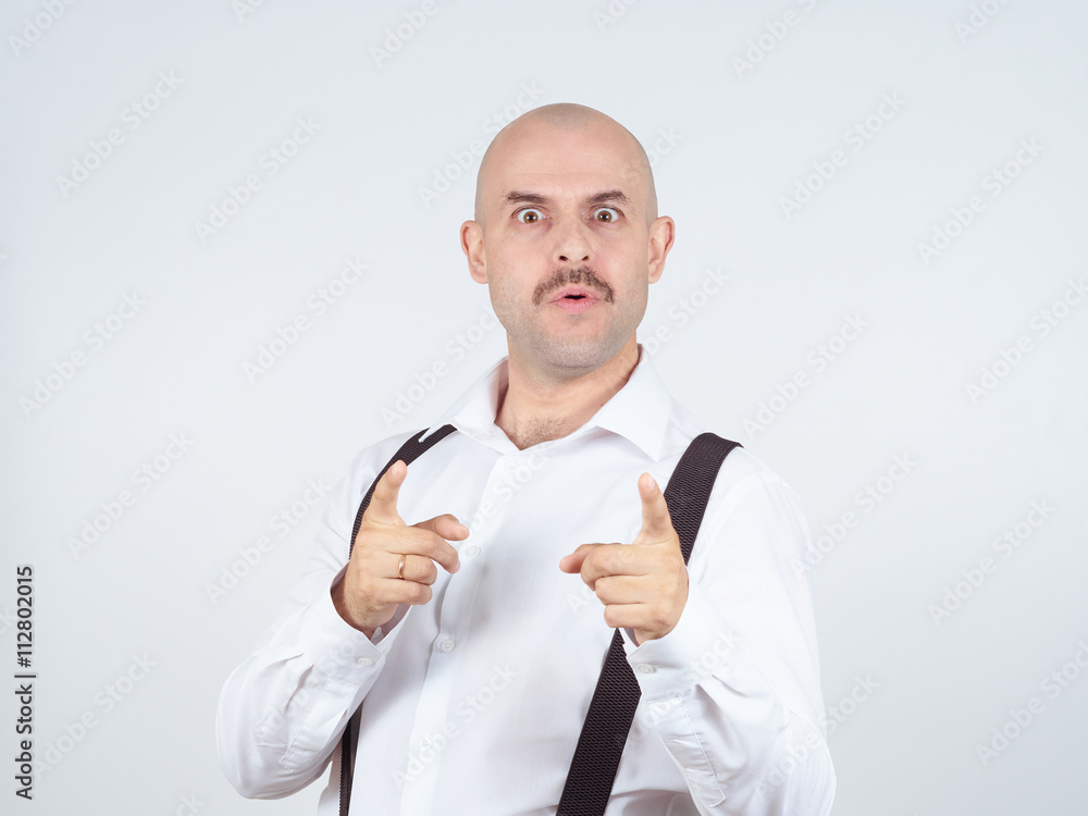 Bald businessman pointing at the camera with. Bald businessman pointing at the camera with.