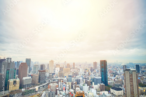 Business concept for real estate and corporate construction - panoramic modern city skyline bird eye aerial view with dramatic sunrise and morning sky in Osaka, Japan