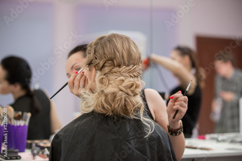 Application of wedding makeup. Preparation of the bride. Boho style. Ease of braided hair braids.