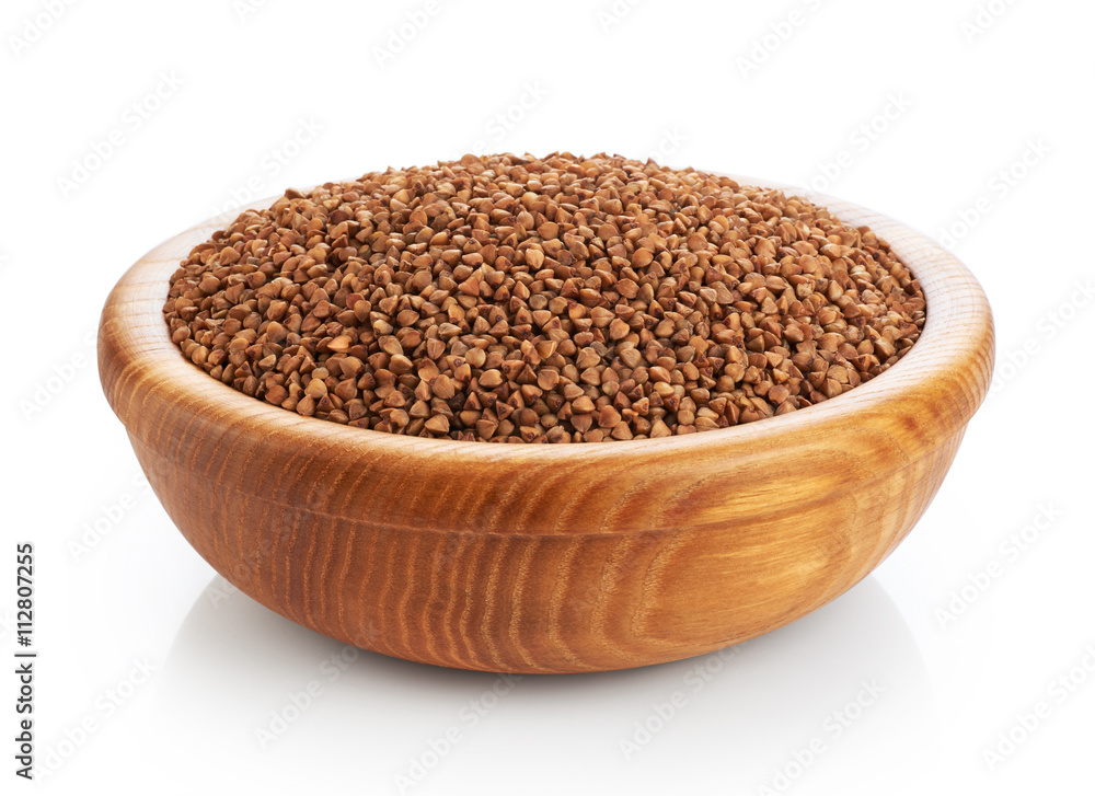 Wooden bowl with buckwheat isolated on white background. Wooden bowl with buckwheat isolated on white background.