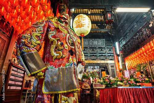 God statue in traditional old oriental chinese temple in Taiwan (Chinese Translation on lantern : name of the chinese god of sea, mazu(matsu))