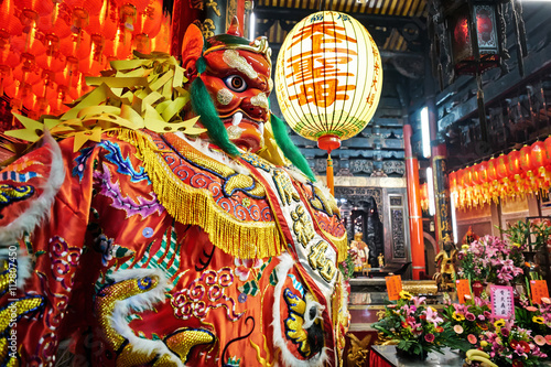 God statue in traditional old oriental chinese temple in Taiwan (Chinese Translation on lantern : name of the chinese god of sea, mazu(matsu)) photo