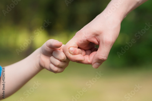 Man and young boy play with hands © SasaStock