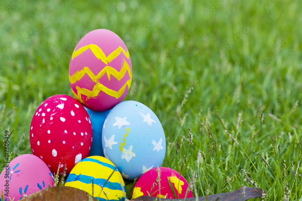 Colorful Easter eggs in the grass on the green grass