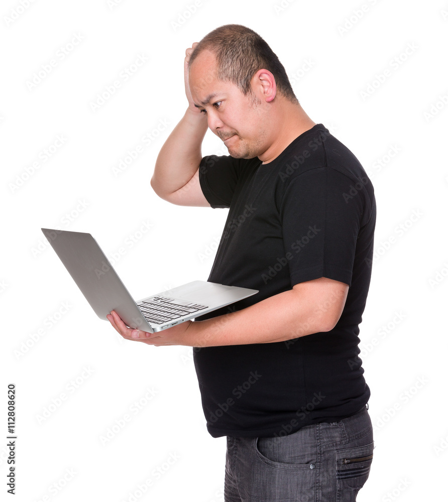 Asian man having problem on laptop computer Asian man having problem on laptop computer