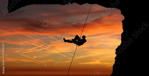 Silhouette of a climber over beautiful sunset © mbolina