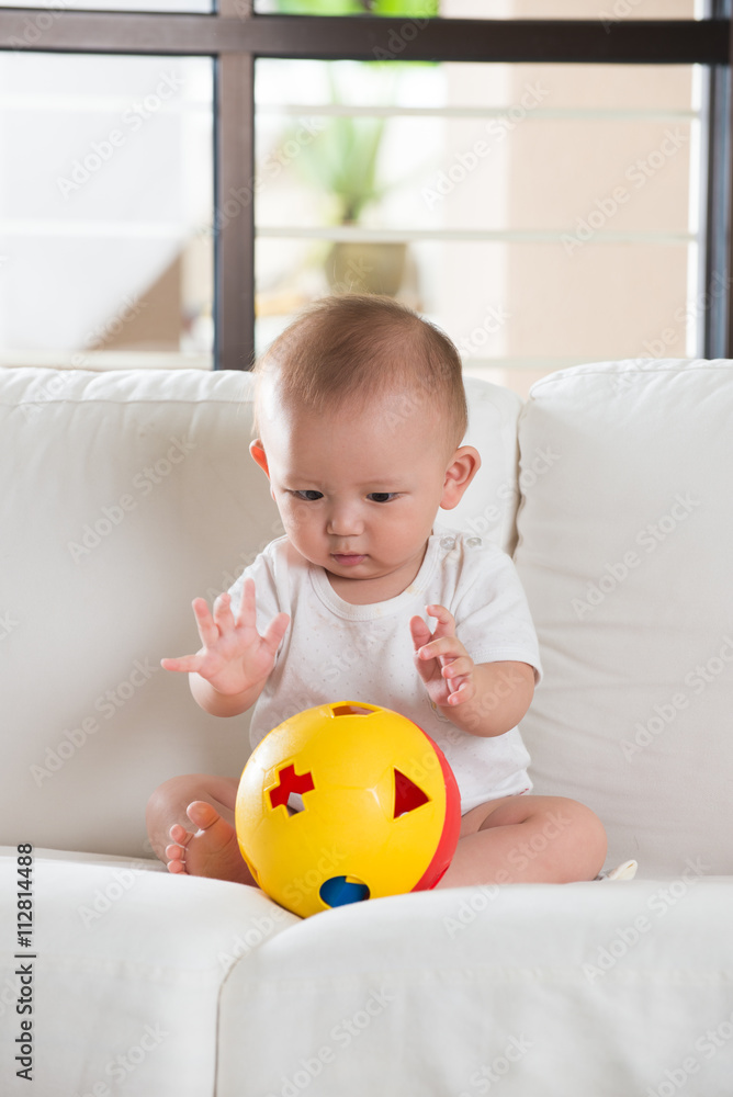 asian baby playing with ball asian baby playing with ball
