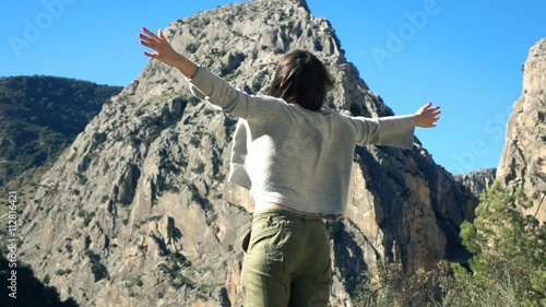 Woman enjoying mountains view and stretching her arms in the country, super slow motion
