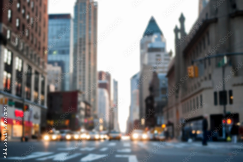 Fototapeta premium Defocused image of midtown 8th Avenue facing downtown, with car headlights blurred