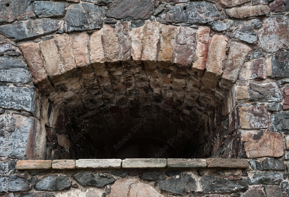 Fototapeta premium Stone wall medieval texture with loophole background