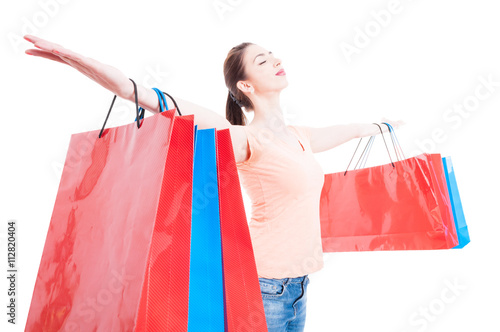 Shopping woman satisfied and happy having arms wide opened conce