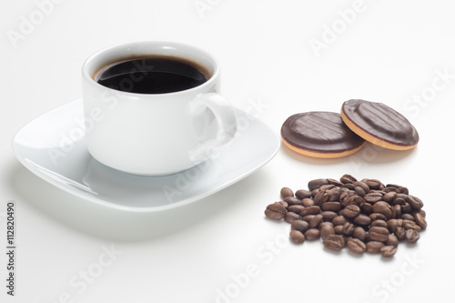 White cup  black coffee  beans and cakes