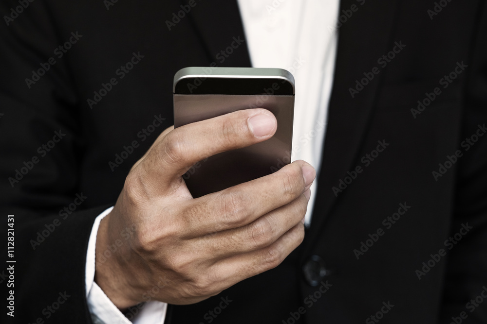 Close-up businessman hand, using smart phone Close-up businessman hand, using smart phone