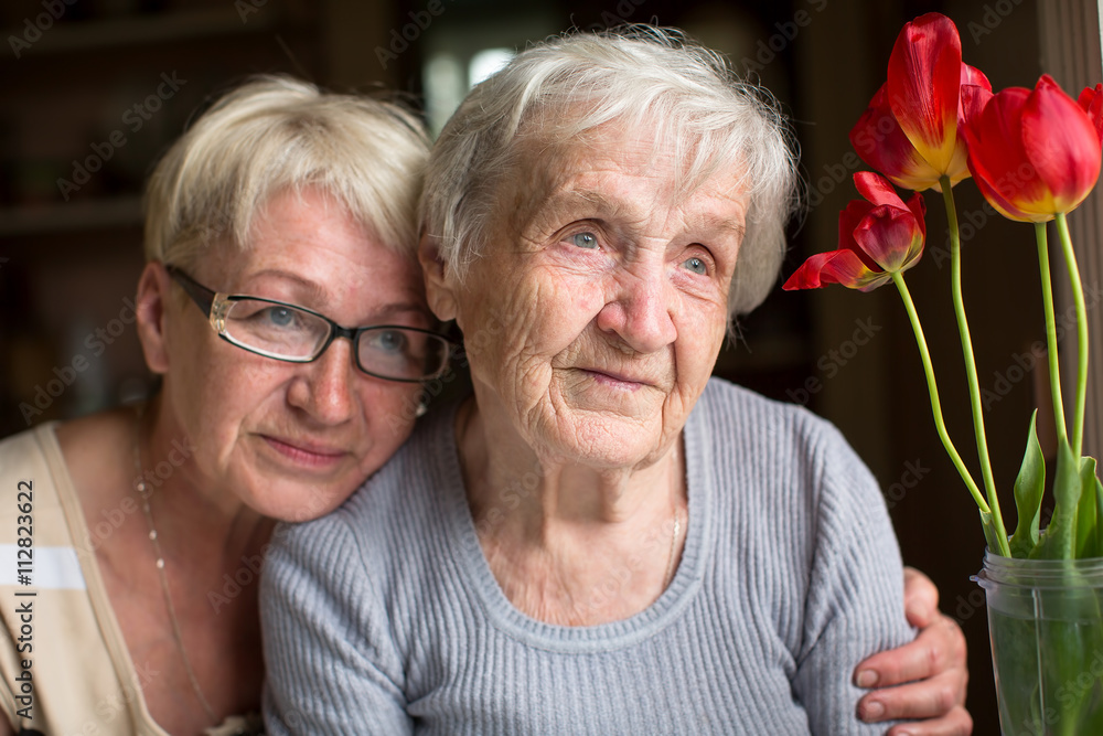 Woman sitting with her elderly mother.