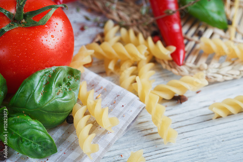 Italian food background, with tomatoes, basil, pasta, olive oil,