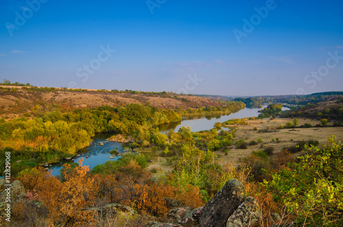Rural autumn sunrise landscape with river and colorful trees, seasonal background